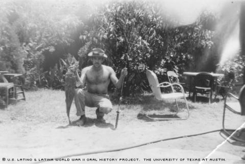 Toby Fuentes behind his dad's house on 6th street in Austin, Tx.Toby shows his fishing trophy.