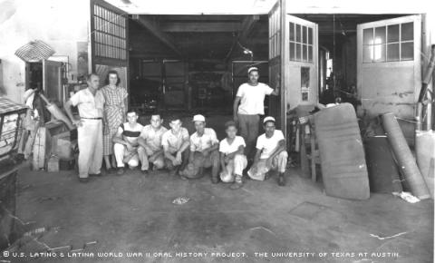 Toby Fuentes (standing right)relaxes at a body shop in Austin, Tx.