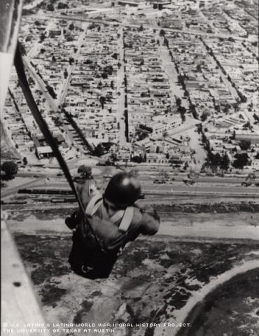 Lt. Ed Peniche, Mexican Army Parachute Infantry battalion, jumps over Balbuena Air Force base at the outskirts of Mexico City; April 1950. Balbuena AFB no longer exists. Peniche was a member of the original Mexican Airborne Cadre in 1946.