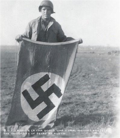 Juan Martinez Jr. holding a Nazi flag.