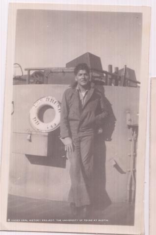 This is a photo of Jesus Munoz in San Diego standing on deck of the USS Brush in work clothes. The photo was taken in 1948 while Munoz was taking a break.