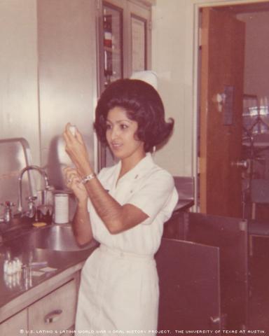 Rita Brock-Perini prepares pain medication for a wounded airman at Wilford Hall U.S. Air Force Medical Center, in San Antonio, Texas, on 1970.