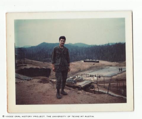 Raymond at the Vietnam firebase Bastonge Ashaw Valley about a month in the country in 1970. The platform in the back is a drop zone for infantry and medivac helicopters.
