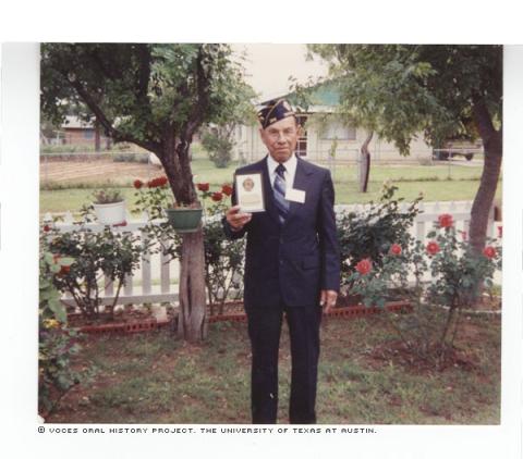 Juan L. Martinez showing his plaque for being Commander of American Legion Post 396 in Crystal City, Texas from September 1987 to 1991.
