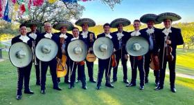 Mariachi Los Galleros in a line, holding their instruments
