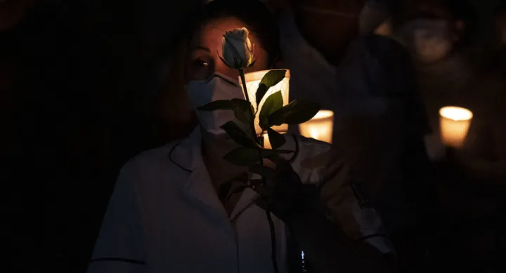 Mourners hold candles during a vigil in Baja California.