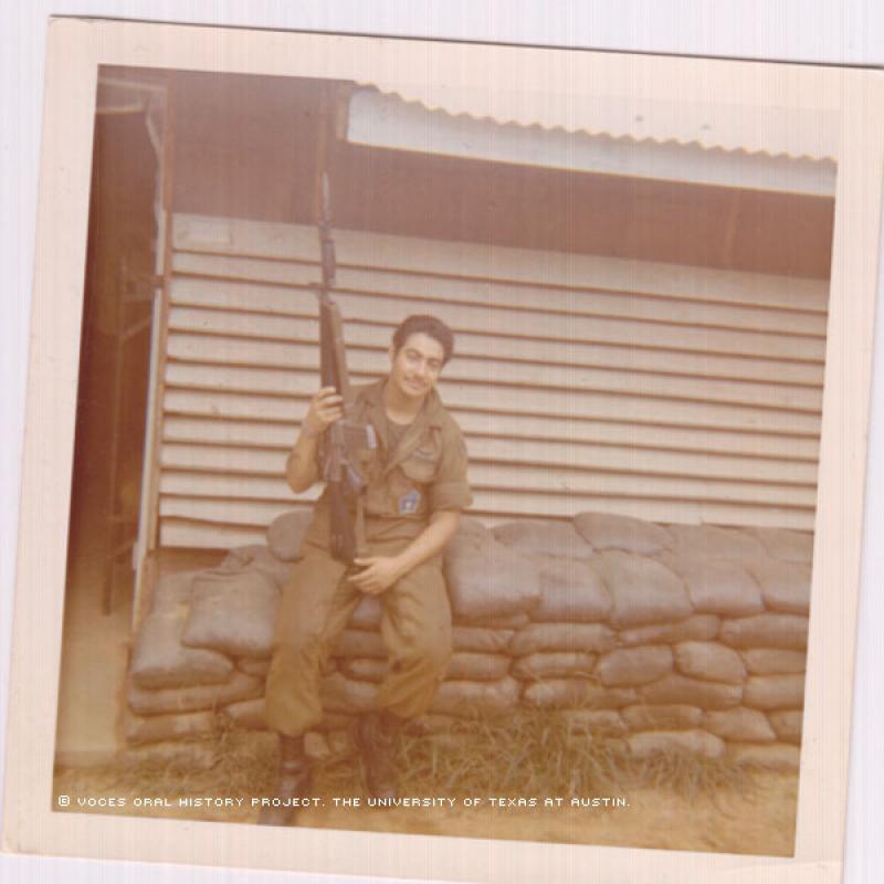 Ernesto Torres at the Lane Air Field Base in front of his barracks (Hooch) in April 1971.\Holding my M16 rifle.\""